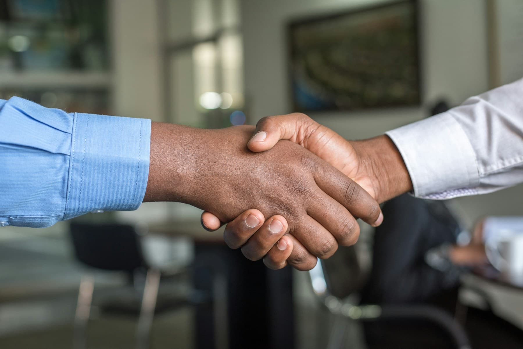 Borrower and advisor handshake during a mortgage consultation